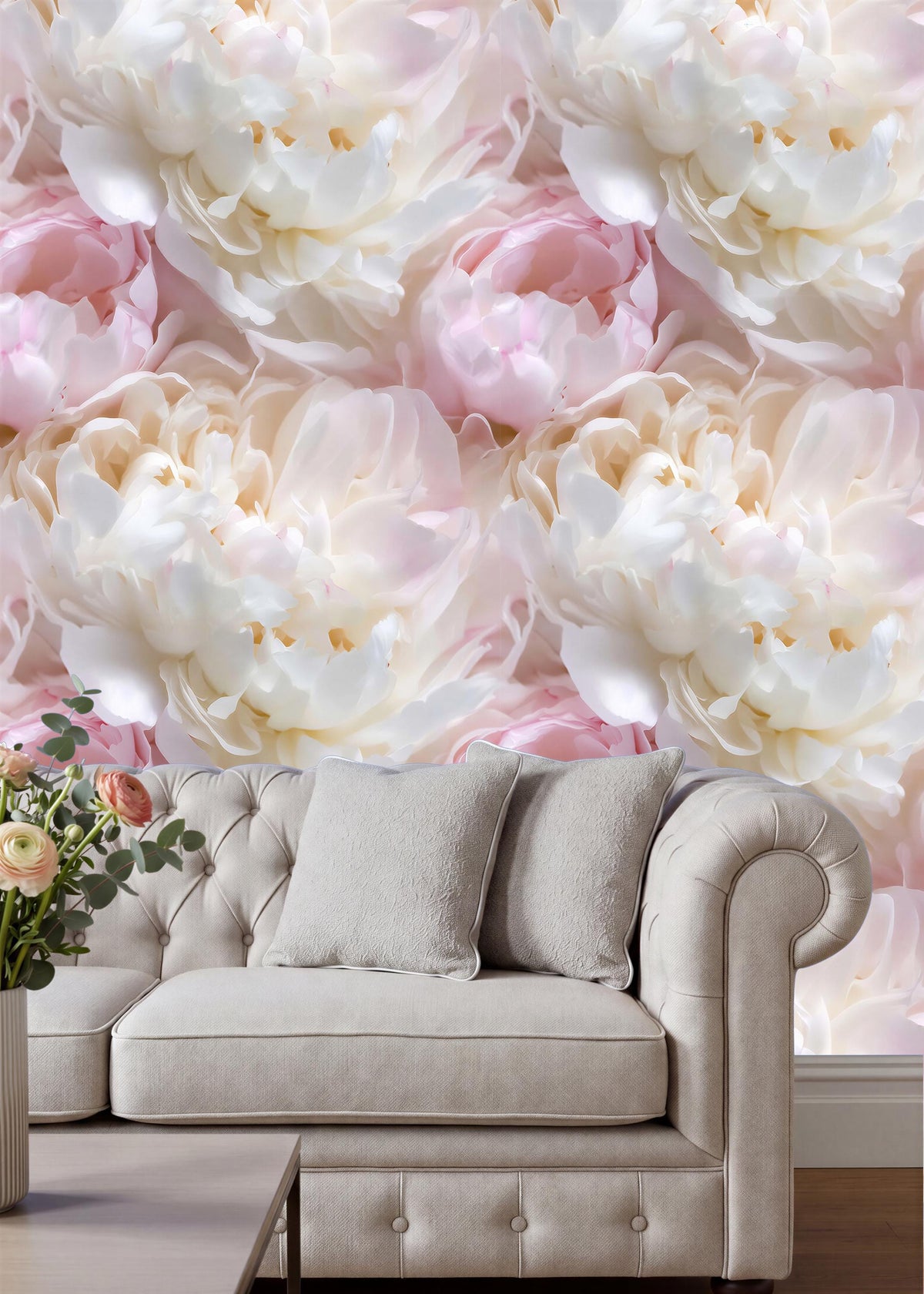 a large floral wallpaper with white and pink flowers, creating a beautiful and elegant backdrop for a beige sofa with two gray pillows.