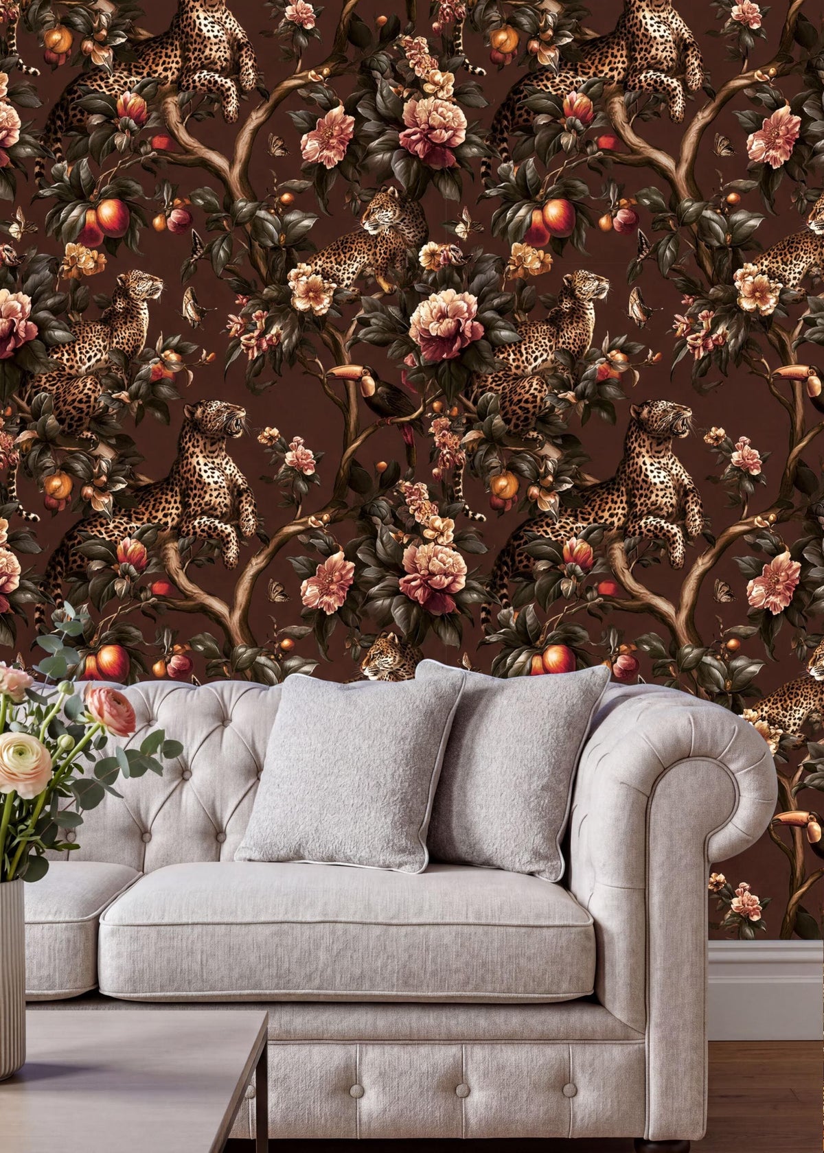 a white sofa with a floral wallpaper behind it, creating a cozy and inviting atmosphere.