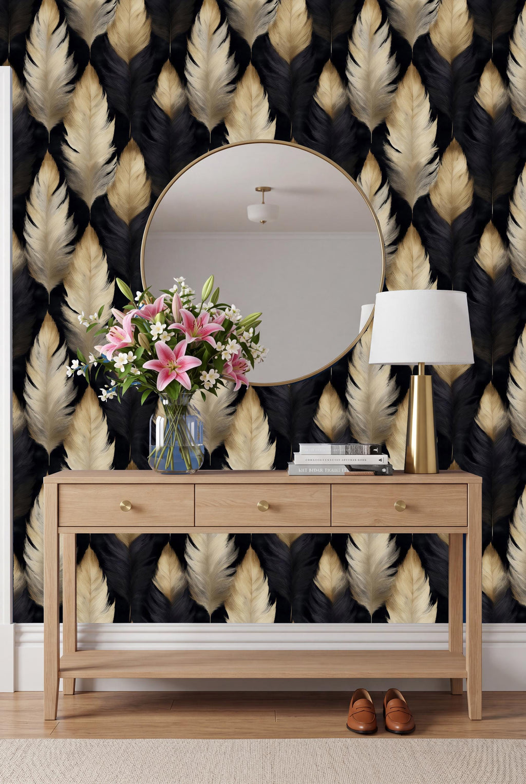 a wooden console table with a round mirror above it, a vase of pink flowers, a lamp, and a pair of brown shoes placed on the floor in front of the table.