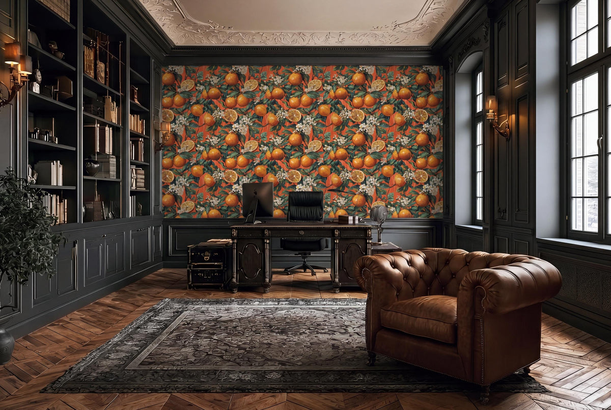 a luxurious and well-appointed home office with a large, vibrant orange and green floral wallpaper covering the wall behind a desk. The desk is accompanied by a comfortable leather armchair, and the room is adorned with numerous bookshelves filled with books and various decorative items.