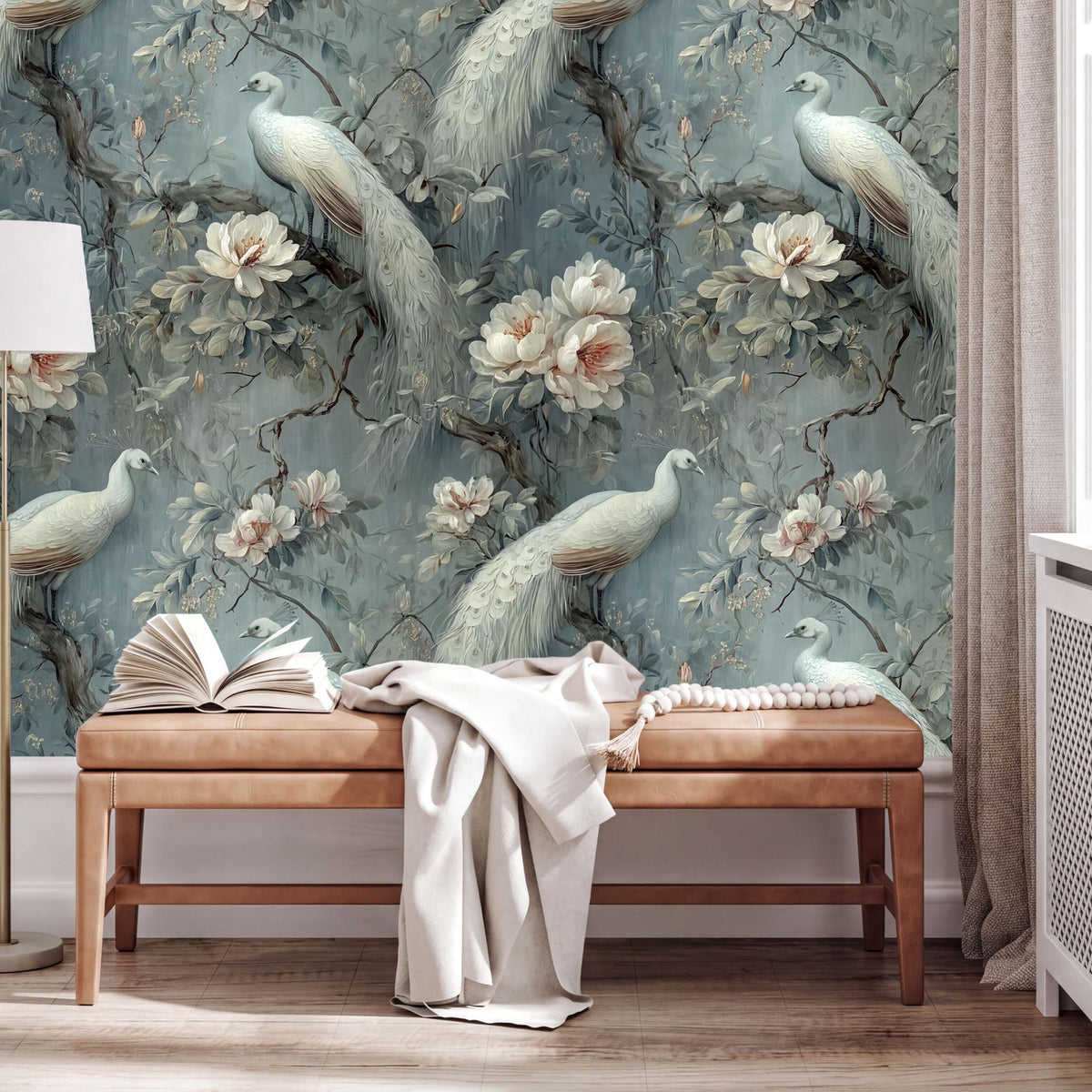 a large wallpapered wall with a floral design, including white peacocks and pink flowers. In front of the wall, there is a wooden bench with an open book and a white blanket on it.