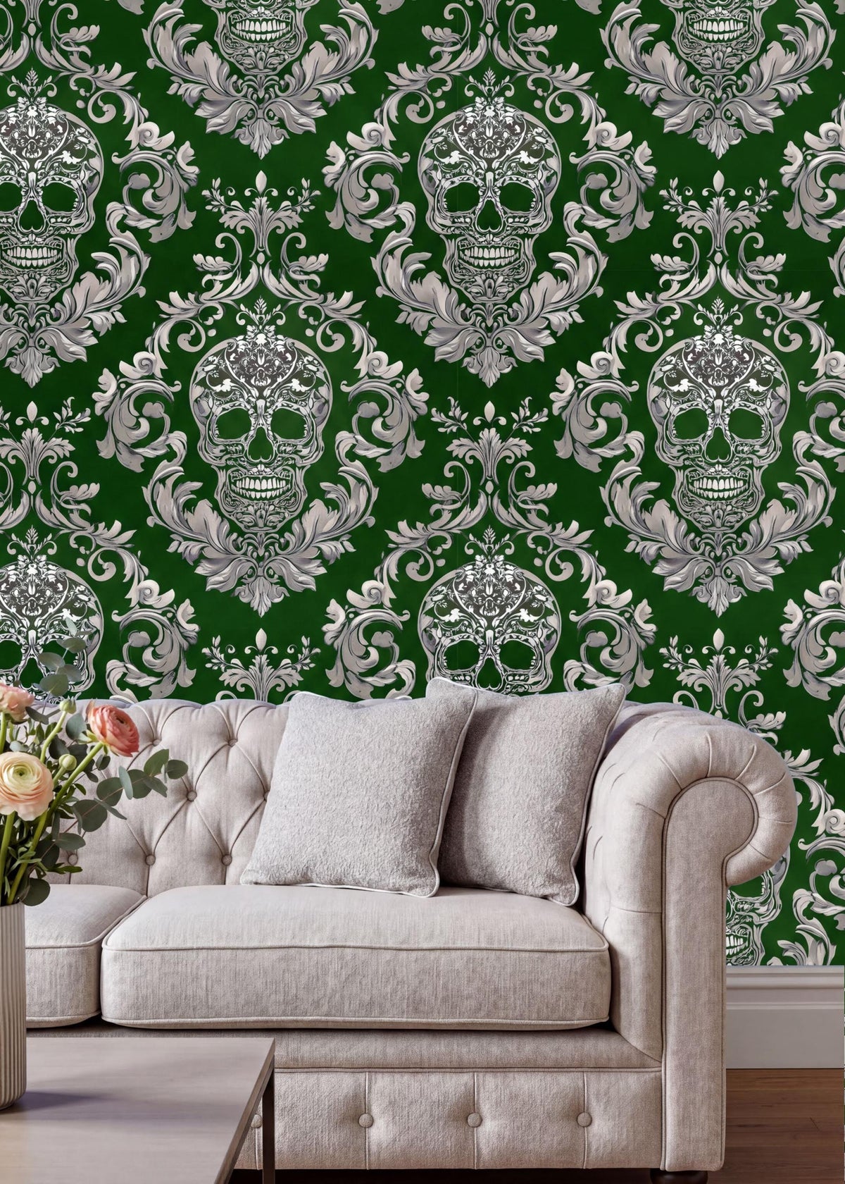 a living room with a white tufted sofa and a coffee table. The sofa is positioned against a wall with a repeating pattern of green and white skulls and ornate designs. The coffee table is placed in front of the sofa, creating a cozy and inviting seating area.