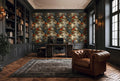 a luxurious and well-appointed home office with a large, ornate wallpaper featuring a floral pattern. The room is furnished with a tufted leather armchair, a wooden desk with a computer, and a large bookshelf filled with books. The room has a high ceiling with intricate molding and a large window that allows natural light to flood the space.