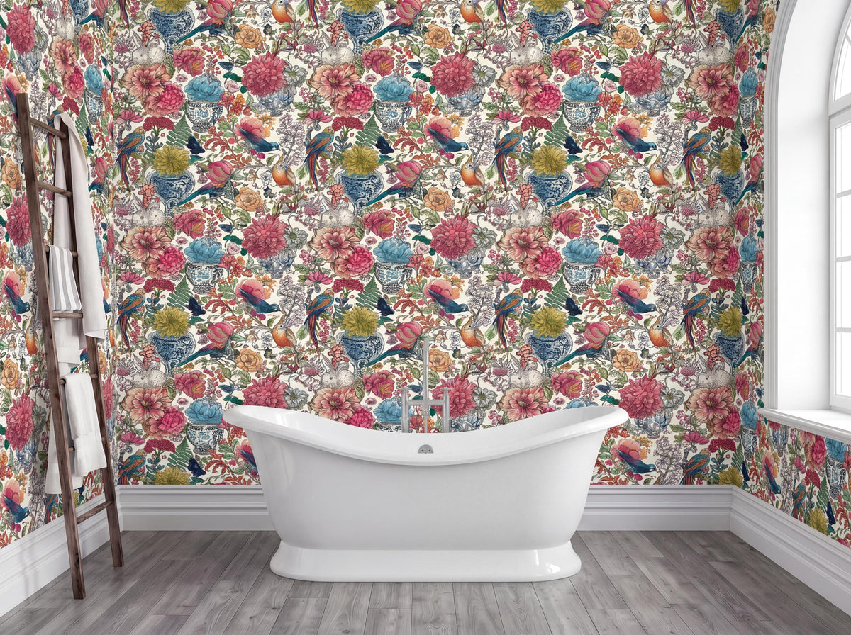 a bathroom with a white freestanding bathtub in the center, surrounded by a vibrant floral wallpaper. The walls are adorned with a colorful floral pattern, creating a lively and cheerful atmosphere. A window is visible on the right side of the image, allowing natural light to enter the space.