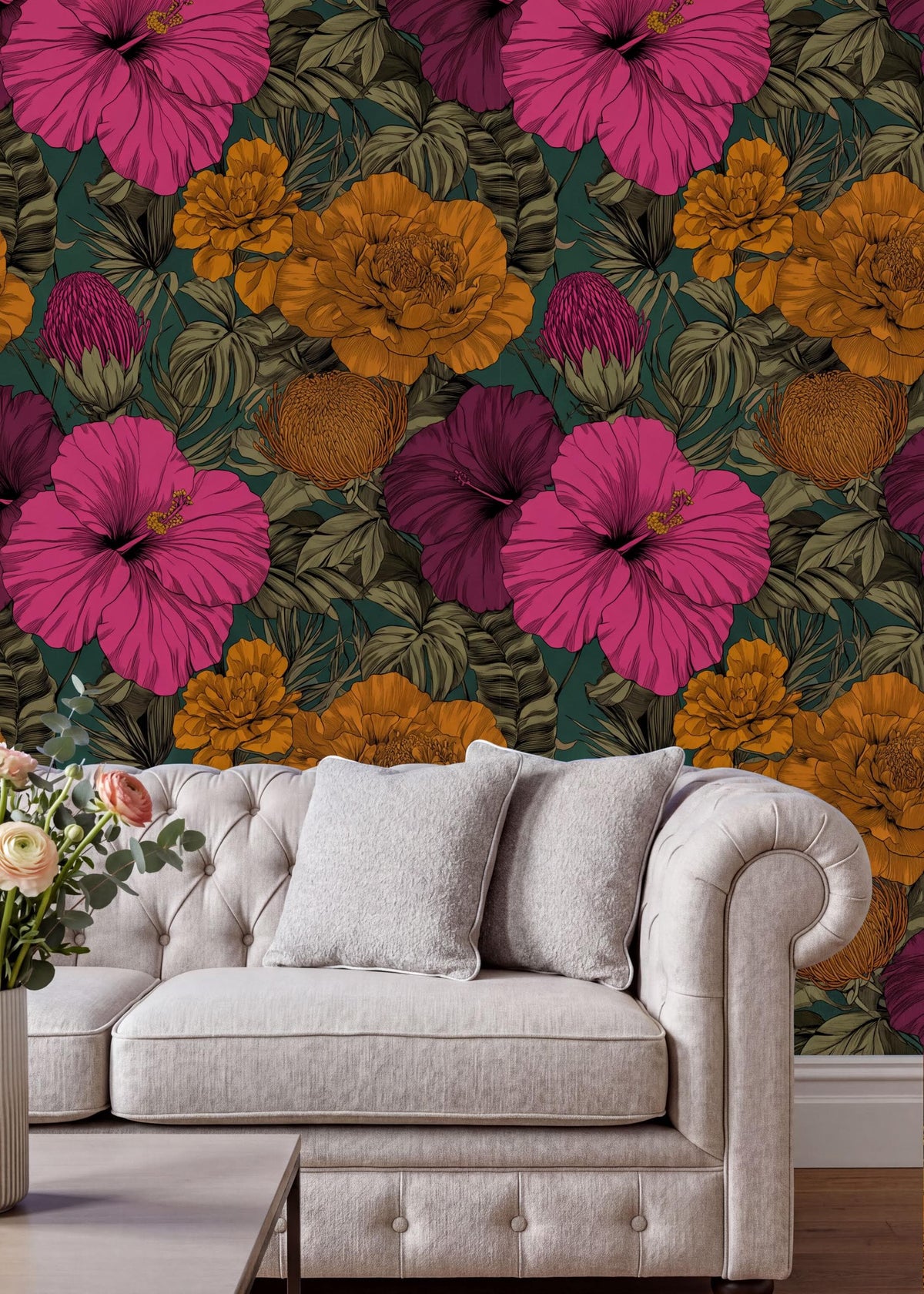 a vibrant floral wallpaper with a variety of colorful flowers, including pink, orange, and yellow blooms, set against a dark green background. In the foreground, there is a white tufted sofa with a single white pillow, and a vase of flowers on a nearby table.