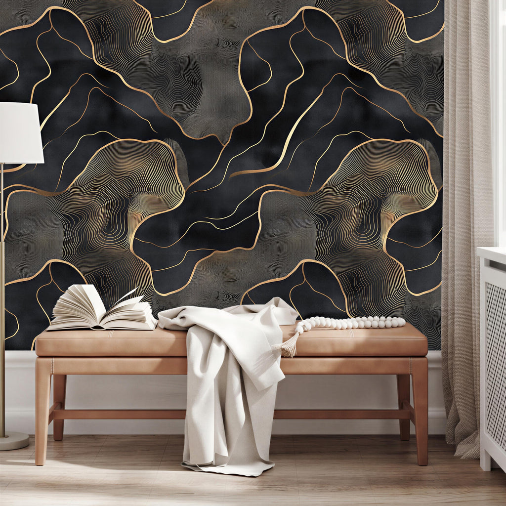 a modern living room with a dark and gold abstract wallpaper design on the wall behind a wooden bench. The bench is positioned in front of the wall, and there are two open books on it.