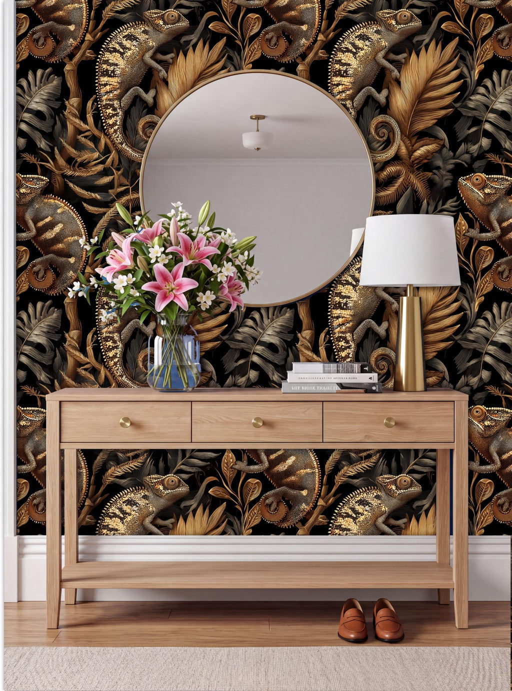 a wooden console table with a round mirror above it, a vase of pink flowers, a lamp, and a pair of brown shoes placed on the floor in front of the table.