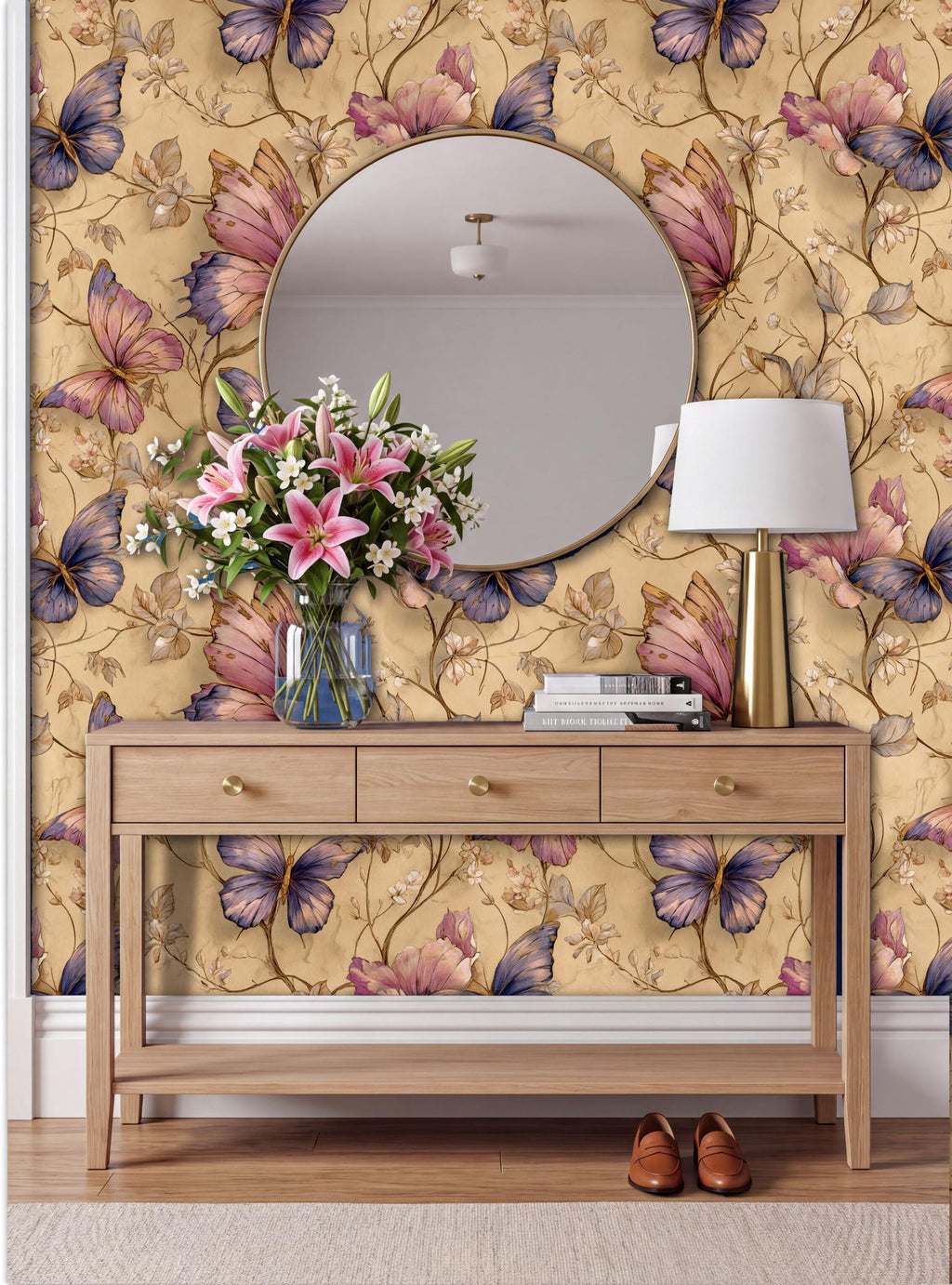 a wooden console table with a round mirror above it, set against a wall with a floral wallpaper. The table has a vase of flowers and a lamp on it, creating a cozy and inviting atmosphere.