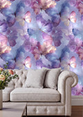 a white sofa with two gray pillows, set against a vibrant and colorful wallpapered wall with a repeating pattern of purple and pink butterflies.