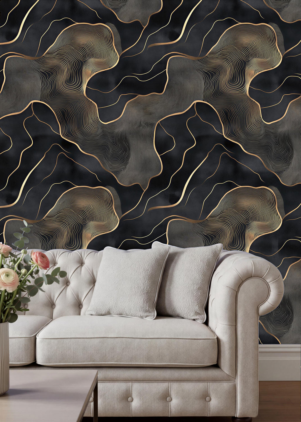 a luxurious living room with a white tufted sofa and a wooden coffee table. The sofa is positioned against a wall with a striking black and gold abstract wallpaper design. The room has a modern and elegant aesthetic, with the white sofa and wooden coffee table complementing the overall design.