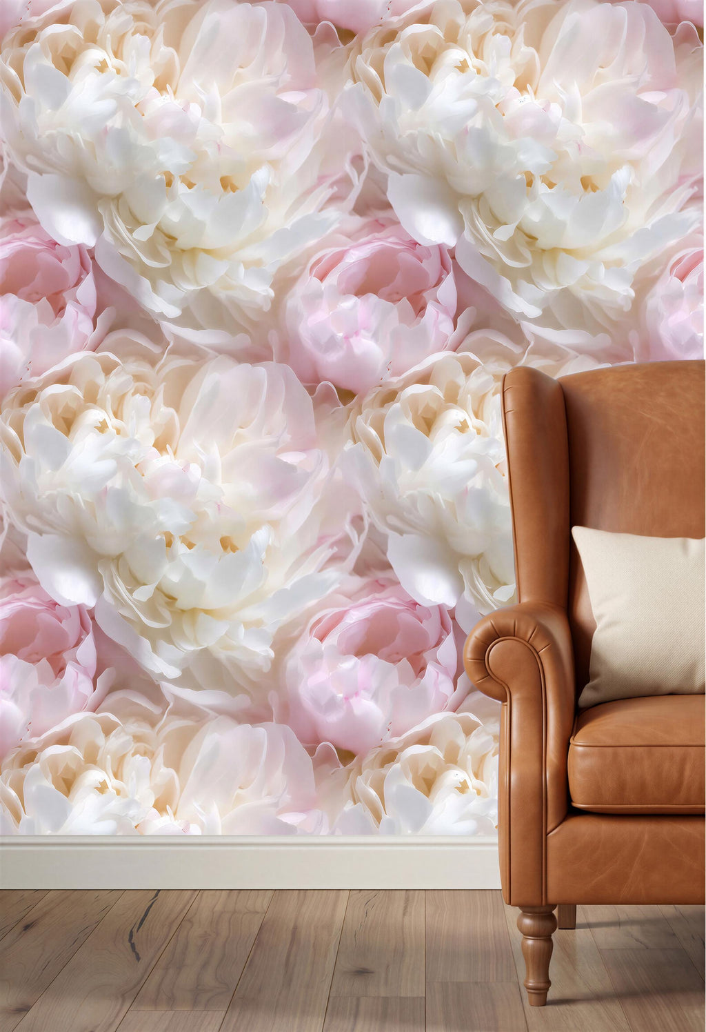 a large floral wallpaper with white and pink flowers covering the wall behind a brown leather armchair.