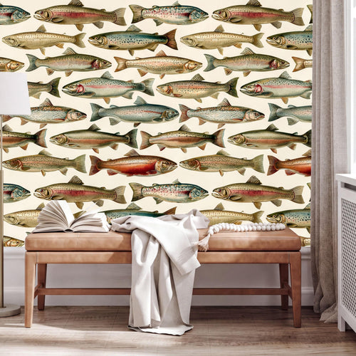 a wallpapered wall with a repeating pattern of fish illustrations, including salmon, trout, and other types of fish. In front of the wall, there is a wooden bench with an open book and a white blanket on it.