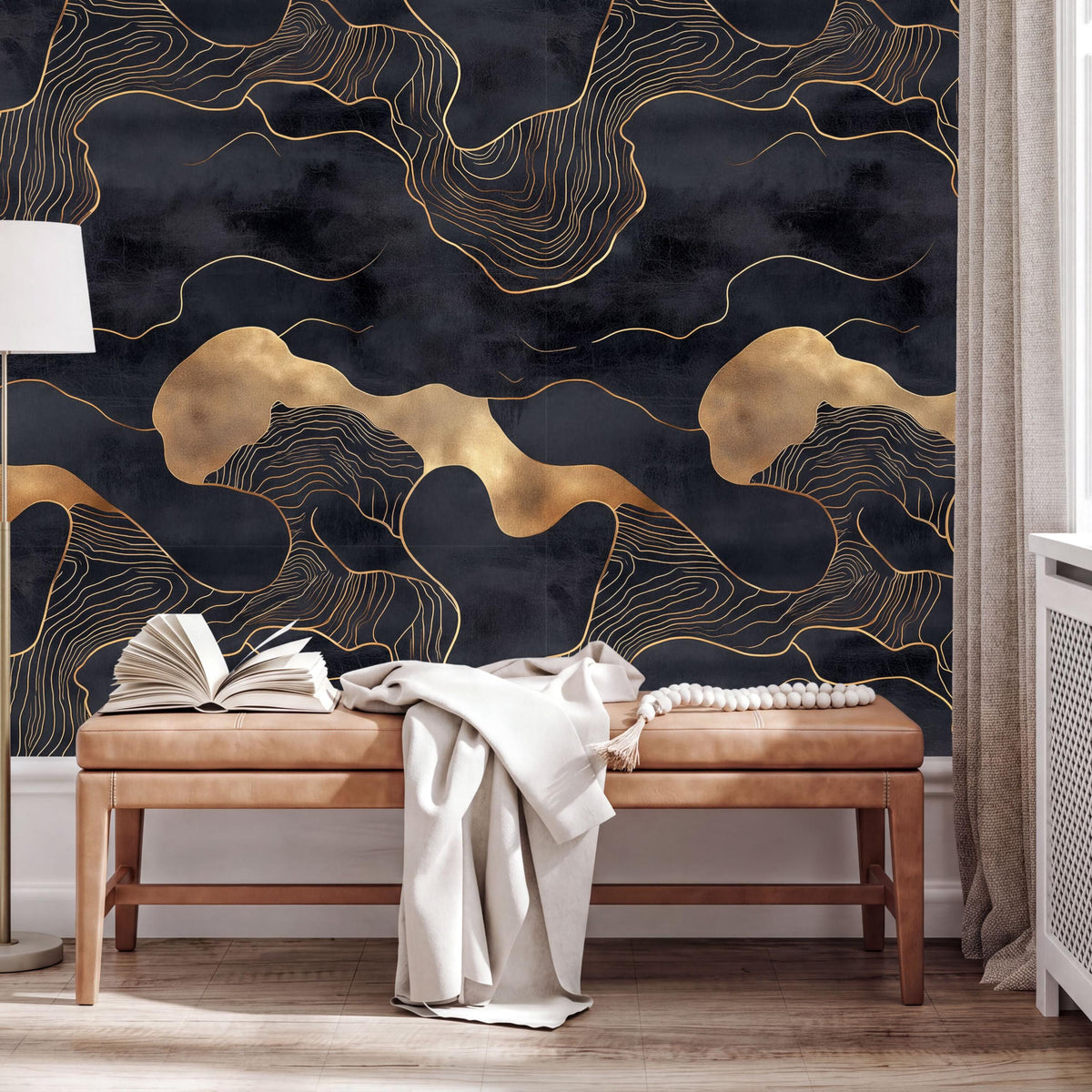 a modern interior design with a black and gold abstract wallpaper pattern on the wall behind a wooden bench. The bench is positioned in front of a window, and there are some books and a white blanket on it.