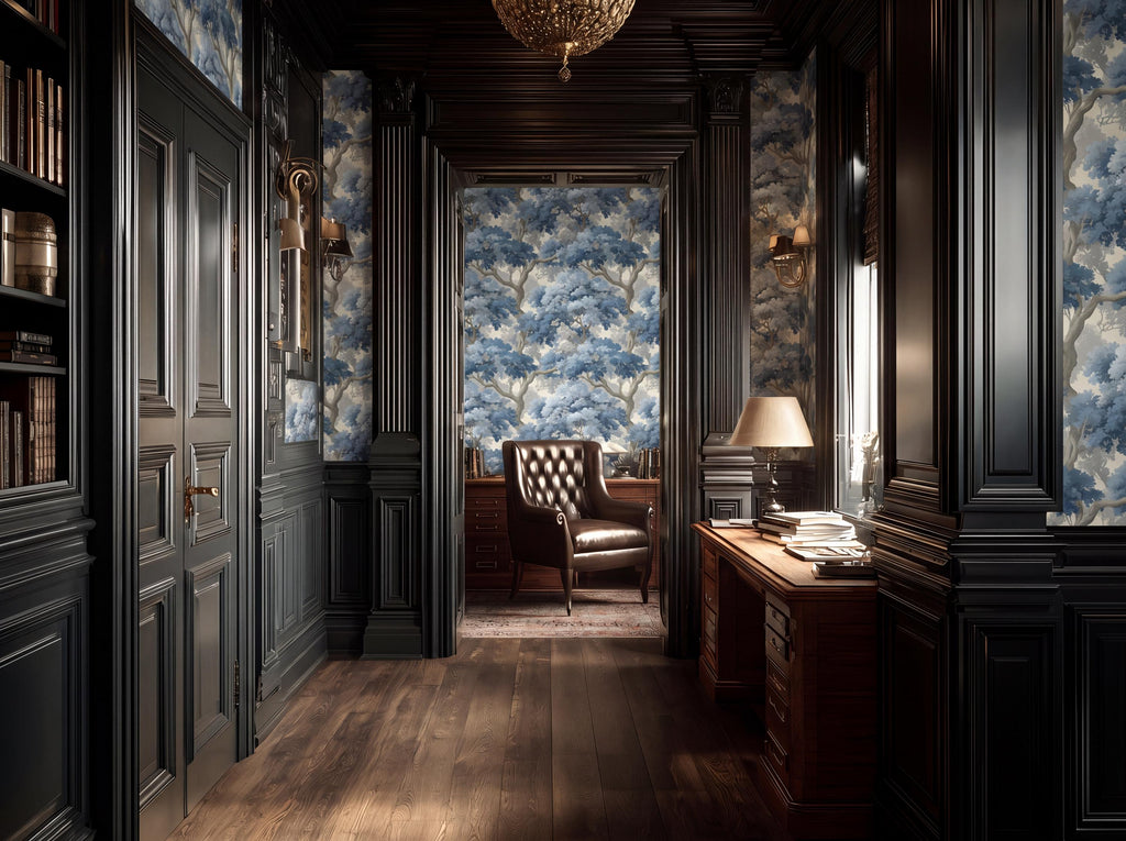 a luxurious and elegant room with dark wood paneling, a plush leather chair, and a desk with a lamp. The room has a high ceiling with a chandelier, and the walls are adorned with blue and white wallpaper featuring a tree pattern. The room is well-lit, with natural light streaming in from a window on the right side.
