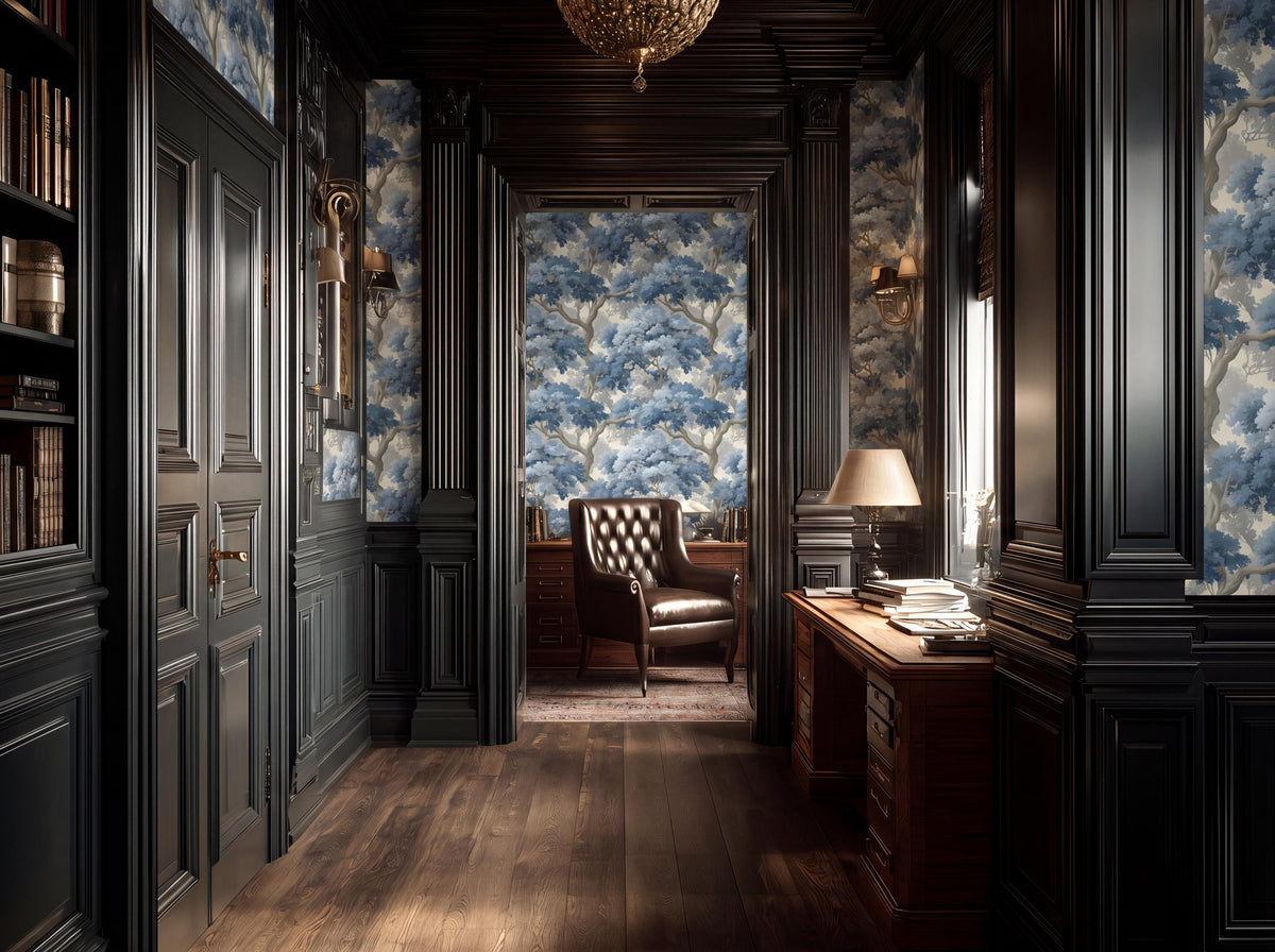 a luxurious and elegant room with dark wood paneling, a plush leather chair, and a desk with a lamp. The room has a high ceiling with a chandelier, and the walls are adorned with blue and white wallpaper featuring a tree pattern. The room is well-lit, with natural light streaming in from a window on the right side.