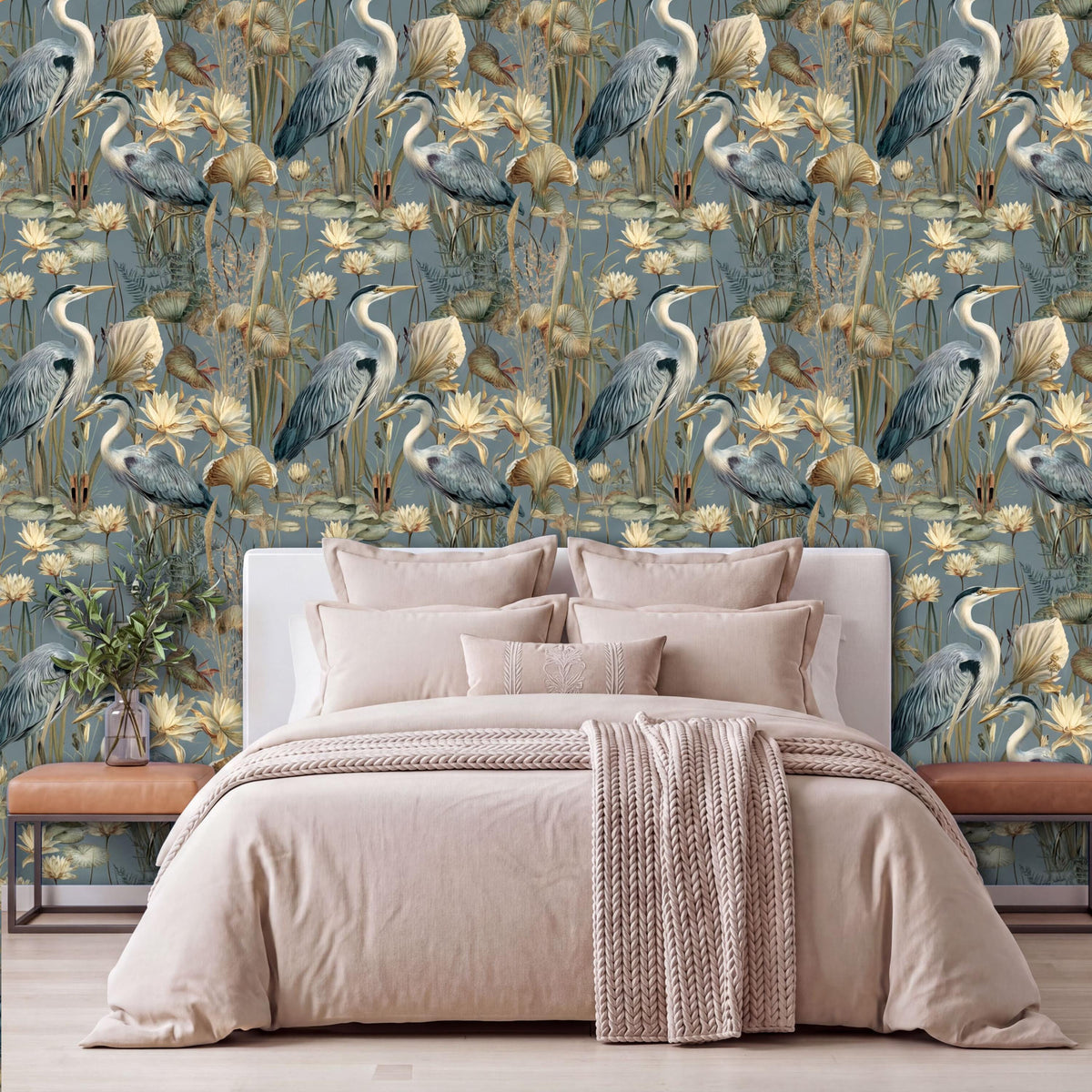 a bedroom with a large bed, a wooden nightstand, and a wallpapered wall with a repeating pattern of blue herons and yellow flowers.