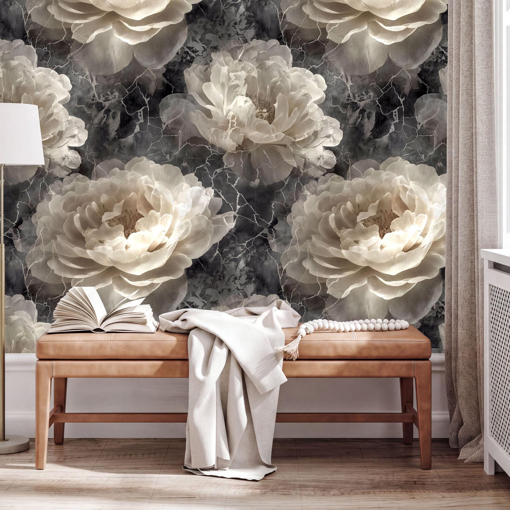 a large floral wallpaper with white and gray tones, creating a serene and elegant atmosphere. In the foreground, there is a wooden bench with an open book and a white blanket draped over it. The overall scene suggests a cozy and inviting space, possibly a living room or a bedroom.
