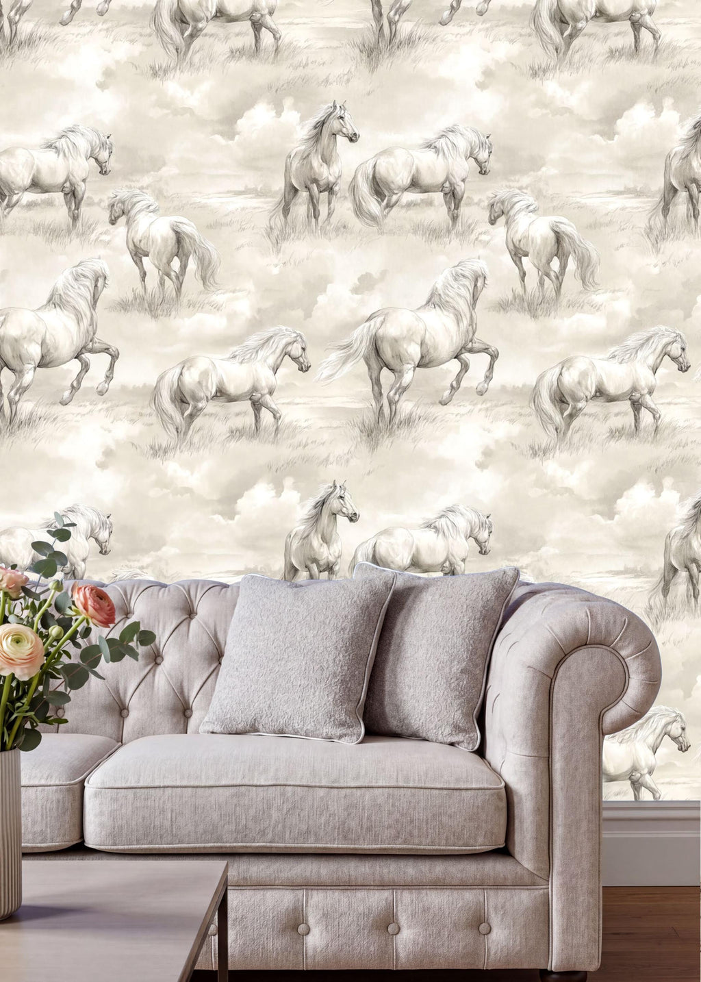 a living room with a gray sofa and a vase of flowers on a table. The wall behind the sofa is covered in a repeating pattern of horses in a field, creating a serene and pastoral atmosphere.