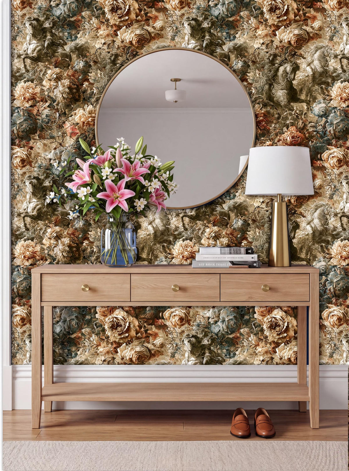 a wooden console table with a vase of pink lilies and a lamp, set against a wall with a floral wallpaper.