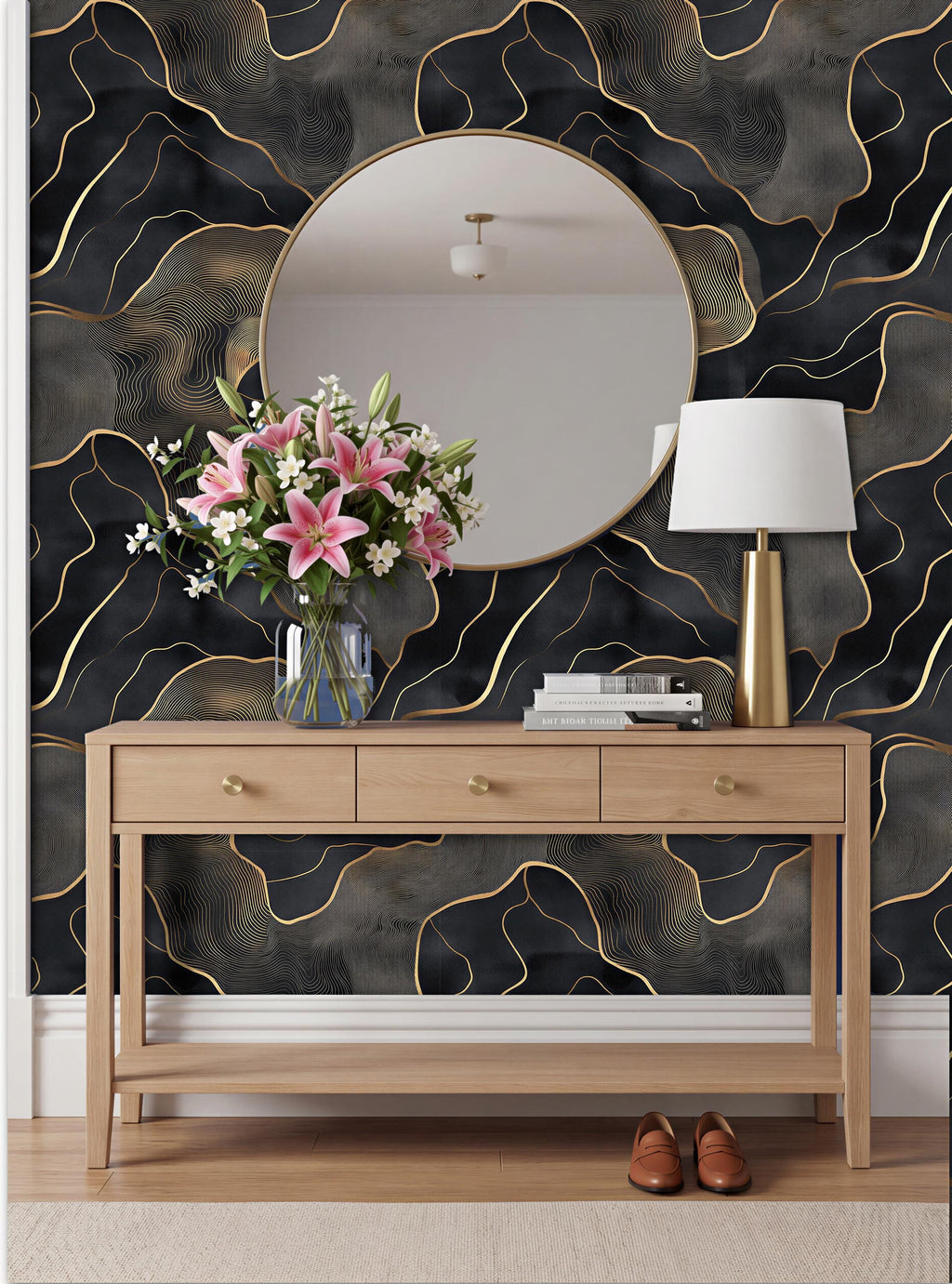 a modern interior design with a wooden console table, a round mirror, a vase of pink flowers, and a lamp. The wall behind the table has a black and gold abstract pattern.