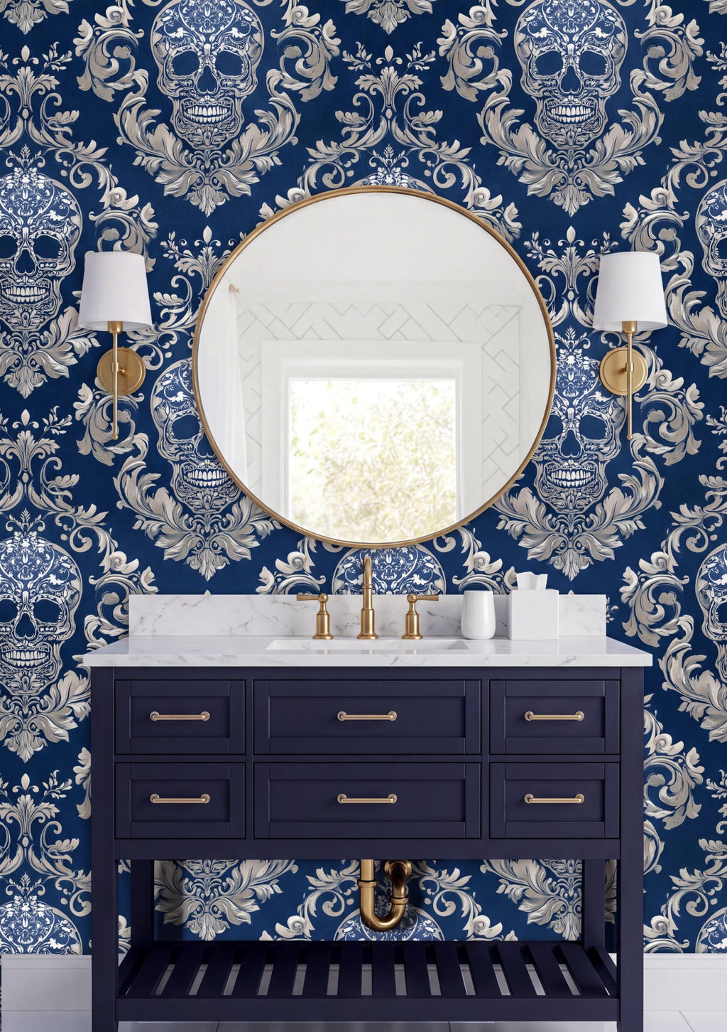 a bathroom vanity with a dark blue color and gold fixtures, including a round mirror and two wall sconces. The wall behind the vanity is covered in a blue and white skull wallpaper, creating a bold and striking visual effect.