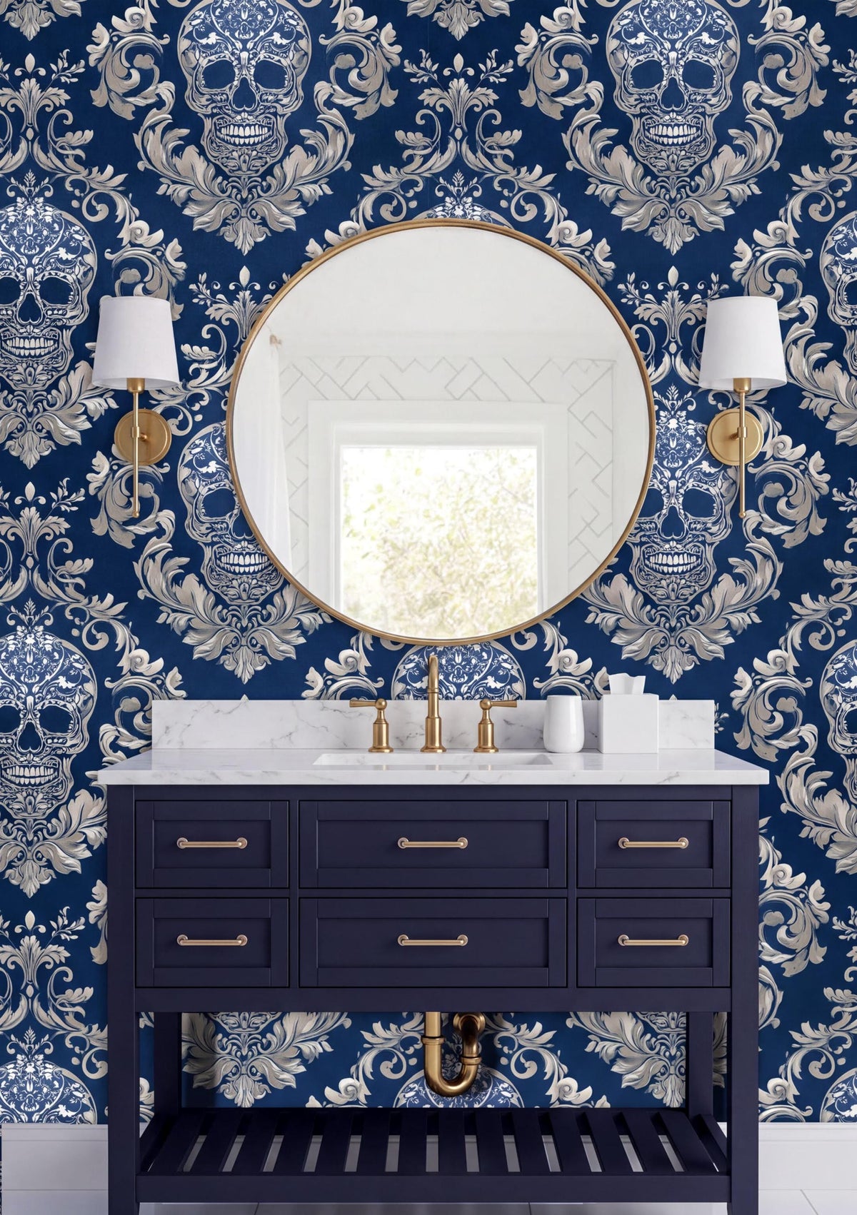 a bathroom vanity with a dark blue color and gold fixtures, including a round mirror and two wall sconces. The wall behind the vanity is covered in a blue and white skull wallpaper, creating a bold and striking visual effect.