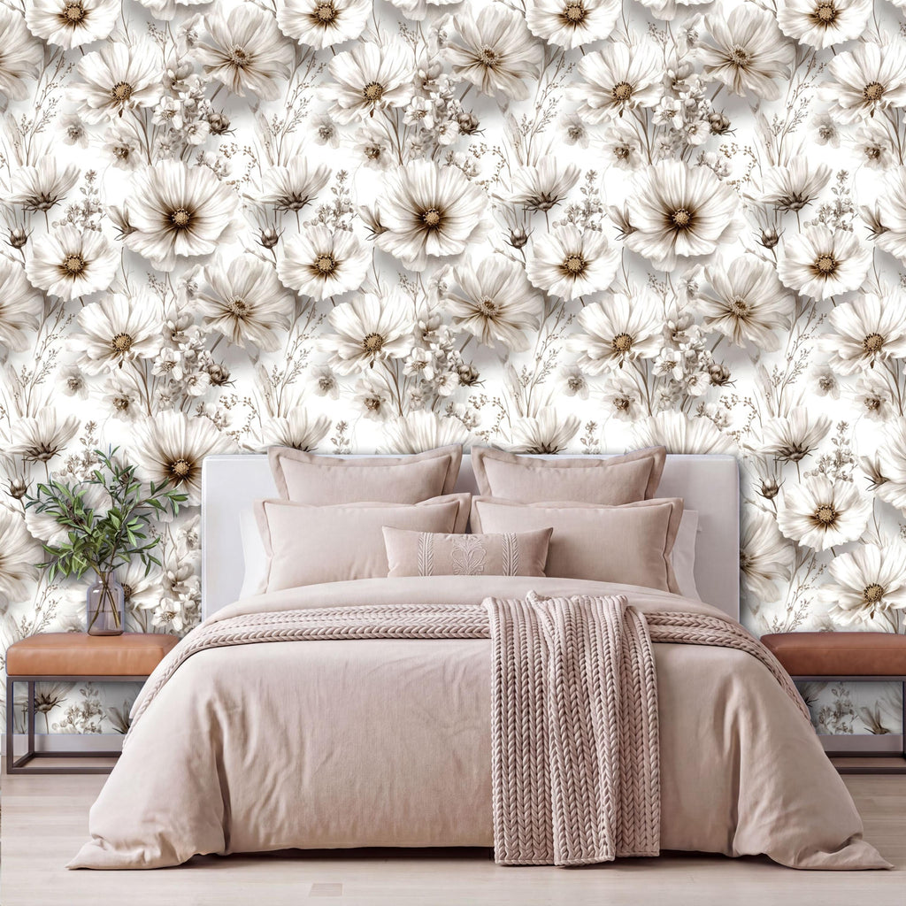 a bedroom with a large floral wallpaper covering the wall behind a bed. The bed is dressed in a beige comforter and has several pillows. There is also a wooden nightstand on the left side of the bed, and a vase of flowers is placed on the nightstand.