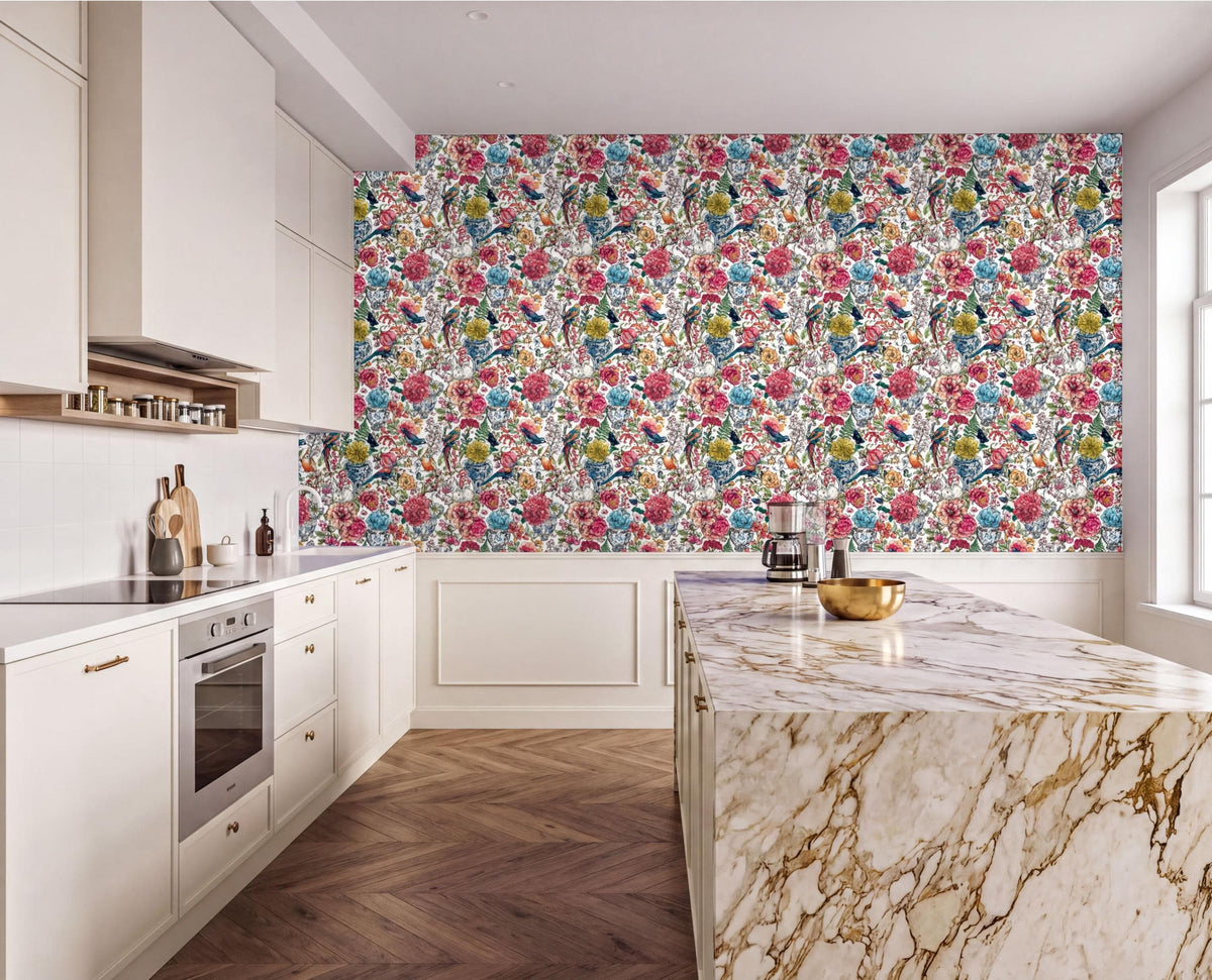 a modern kitchen with a marble countertop and a floral wallpaper accent wall.