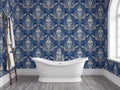 a bathroom with a white clawfoot bathtub in the center, surrounded by a blue and white skull wallpaper. A wooden ladder is leaning against the wall next to the bathtub.