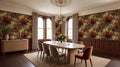 a dining room with a large wooden table surrounded by six chairs. The walls are covered in a vibrant floral wallpaper, and the room features a chandelier and a large window.