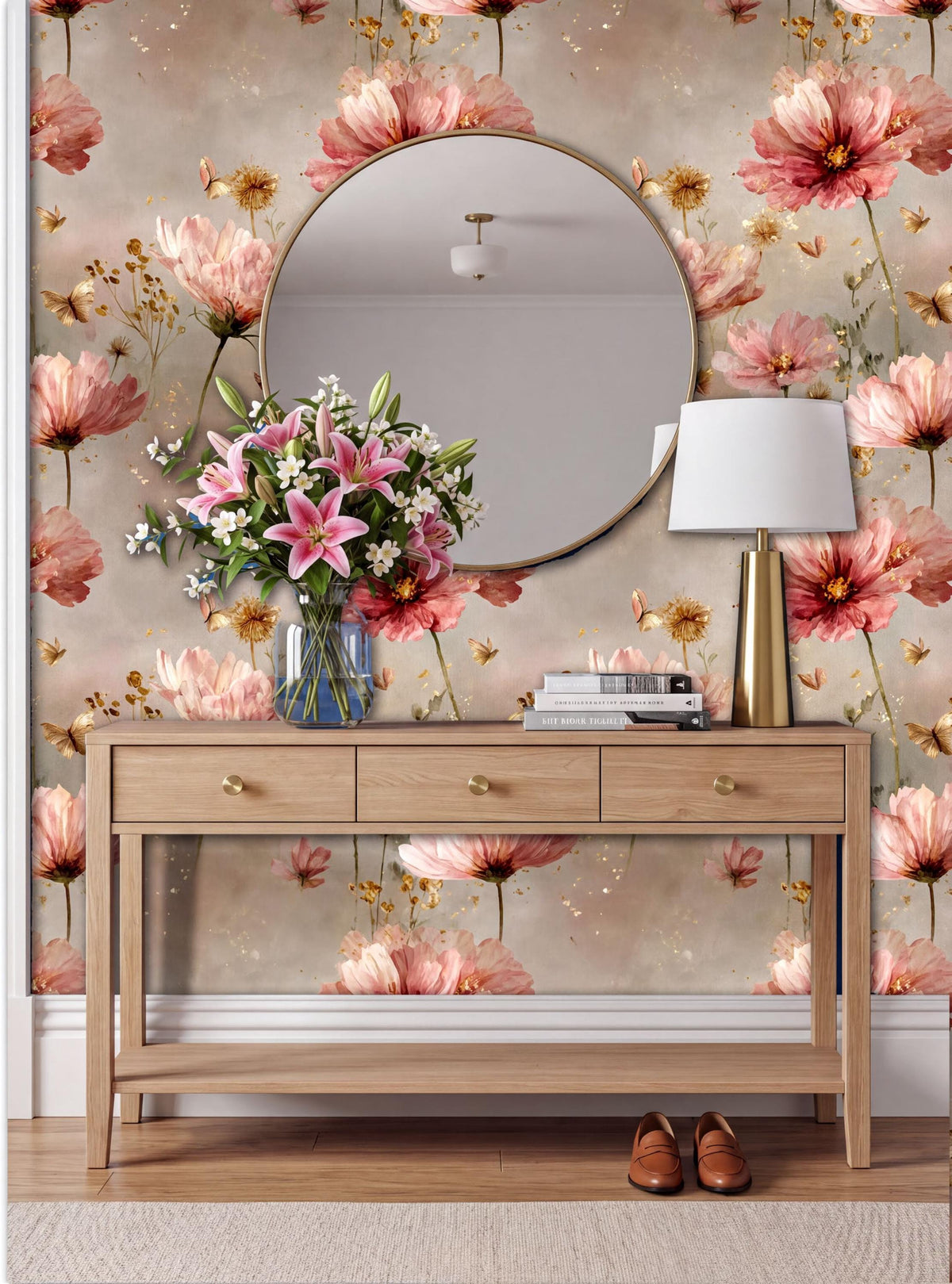a wooden console table with a round mirror above it, set against a wall with a floral wallpaper. The table has a vase of flowers and a lamp on it, creating a cozy and inviting atmosphere.