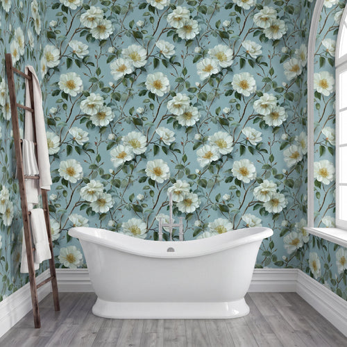 a bathroom with a white freestanding bathtub, a wooden ladder, and a wall covered in a floral wallpaper with white flowers and green leaves.