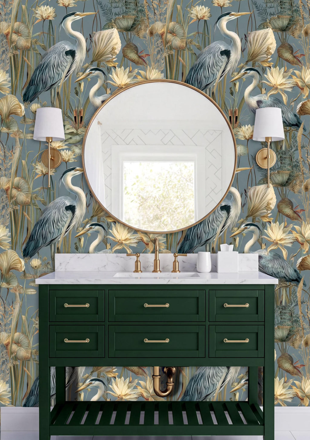 a bathroom vanity with a green cabinet and a round mirror above it. The wall behind the vanity has a floral wallpaper with a repeating pattern of blue and white birds and flowers. There are two white lamps on either side of the mirror, and the overall color scheme of the bathroom is predominantly green and blue.