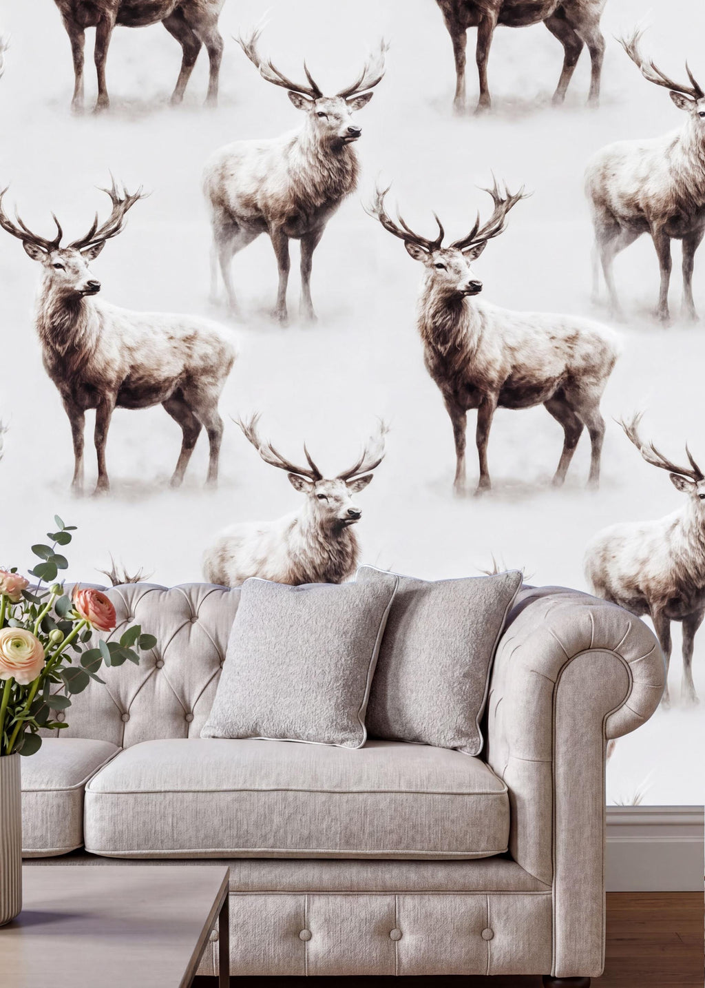 a wallpapered wall with a repeating pattern of deer, including both standing and sitting deer, creating a visually striking and nature-inspired design. In the foreground, there is a gray sofa with a vase of flowers on the armrest, adding a touch of elegance and warmth to the scene.