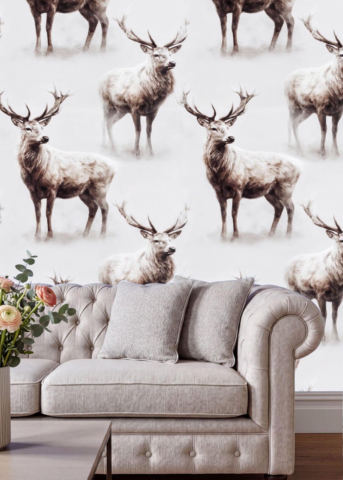 a wallpapered wall with a repeating pattern of deer, including both standing and sitting deer, creating a visually striking and nature-inspired design. In the foreground, there is a gray sofa with a vase of flowers on the armrest, adding a touch of elegance and warmth to the scene.