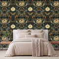 a bedroom with a large bed, a wooden nightstand, and a wallpapered wall with a floral pattern.