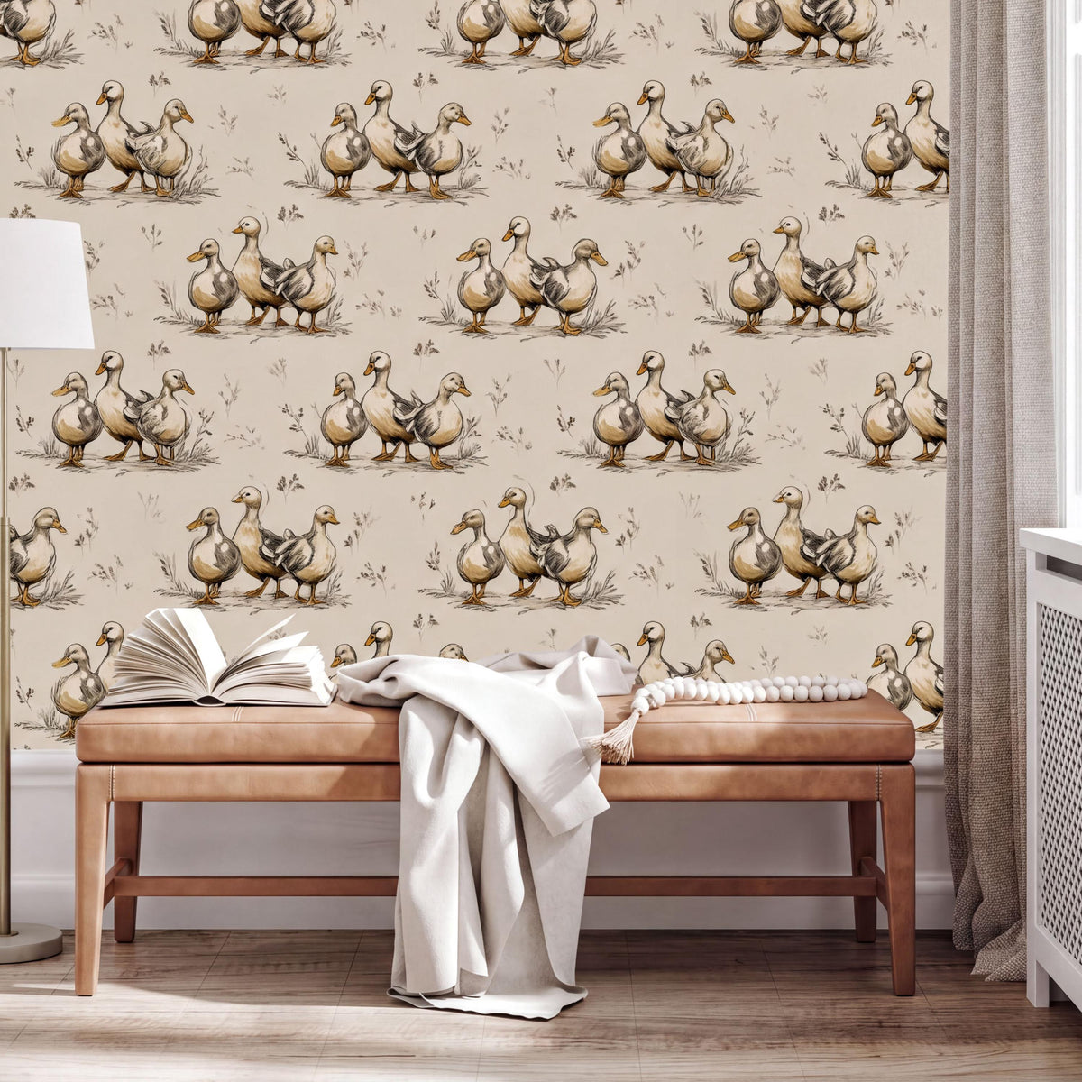 a wallpapered wall with a repeating pattern of ducks, and there is a wooden bench with an open book and a white blanket on it in the foreground.