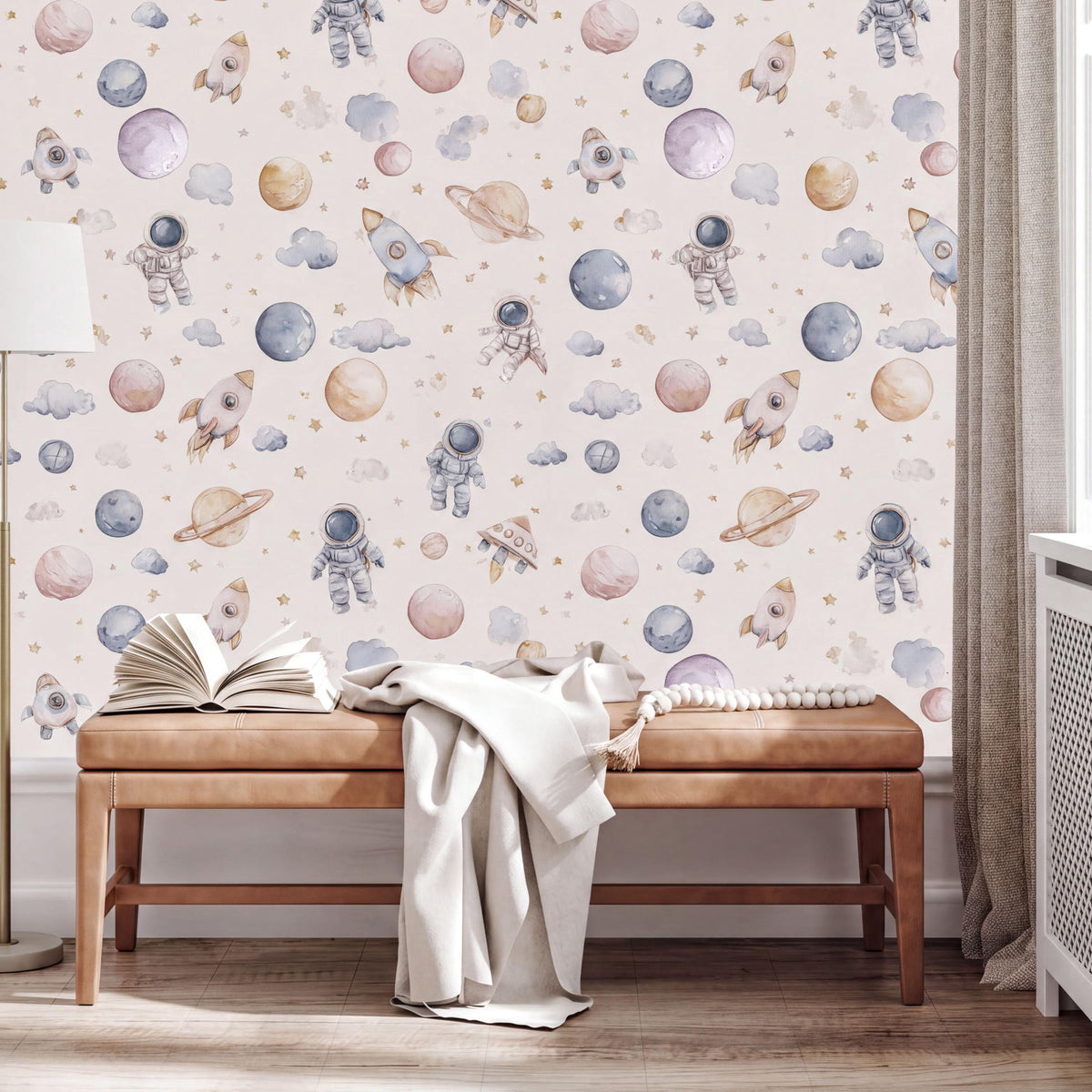 a wallpapered wall with a space-themed wallpaper, including various space-related objects such as planets, stars, and a rocket ship. In front of the wall, there is a wooden bench with an open book on it, and a blanket draped over the bench.