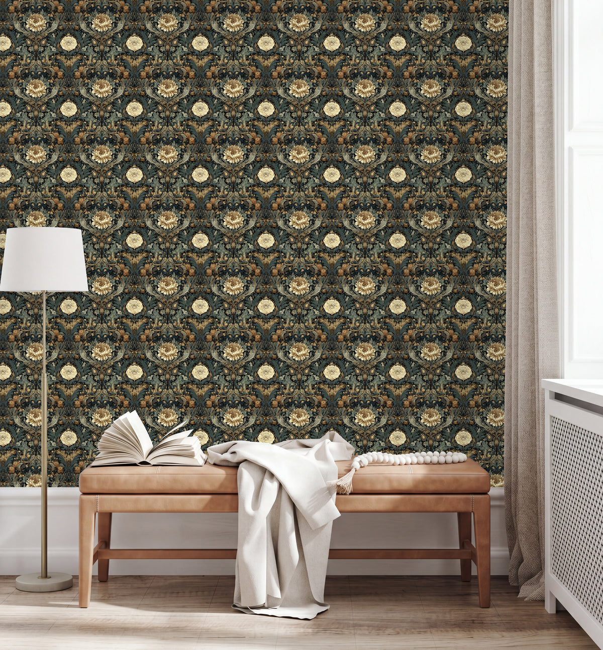 a wooden bench with a white blanket draped over it, positioned in front of a wall with a floral wallpaper. The wall has a repeating pattern of flowers and leaves in shades of green and brown. A lamp is also present in the scene, located on the left side of the bench.