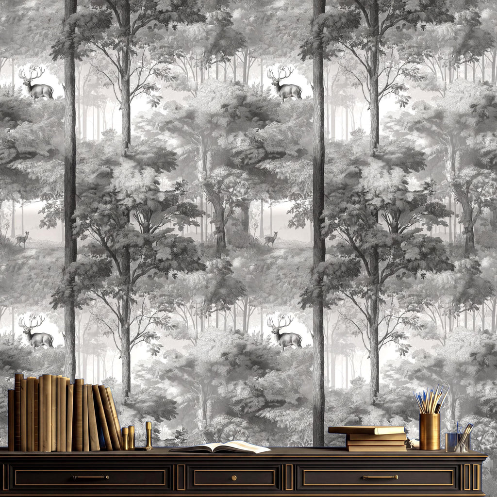 a black and white wallpaper with a forest scene, including deer and trees. In front of the wallpaper, there is a wooden desk with a bookshelf and a vase of flowers.