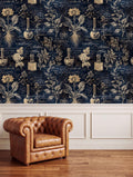 a dark blue wallpaper with intricate botanical illustrations and scientific equipment, such as vials and beakers, creating a vintage or laboratory-inspired atmosphere. In the foreground, there is a brown leather armchair, and the background includes a white wall panel.