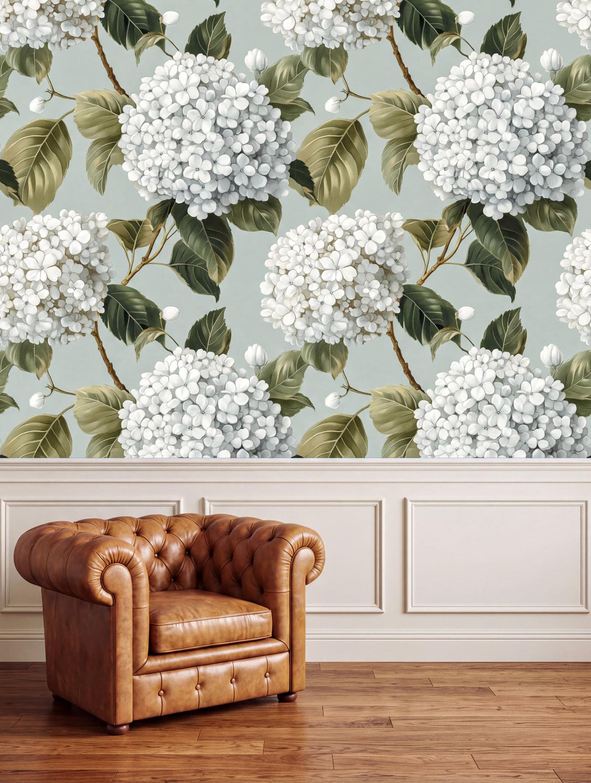 a brown leather armchair positioned in front of a wall with a floral wallpaper pattern of white hydrangeas and green leaves.