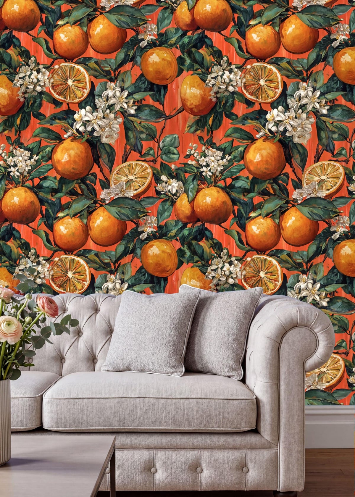 a vibrant orange and white floral wallpaper with orange and white flowers, orange and white flowers, and orange and white flowers, creating a lively and colorful backdrop. In the foreground, there is a white tufted sofa with two gray pillows, and a vase of flowers on a table.