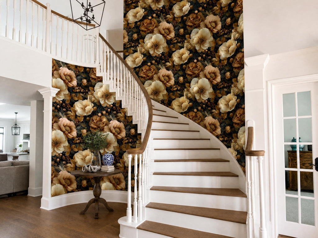 a staircase with a floral wallpaper on the walls, a wooden table with a vase and books, and a white railing.