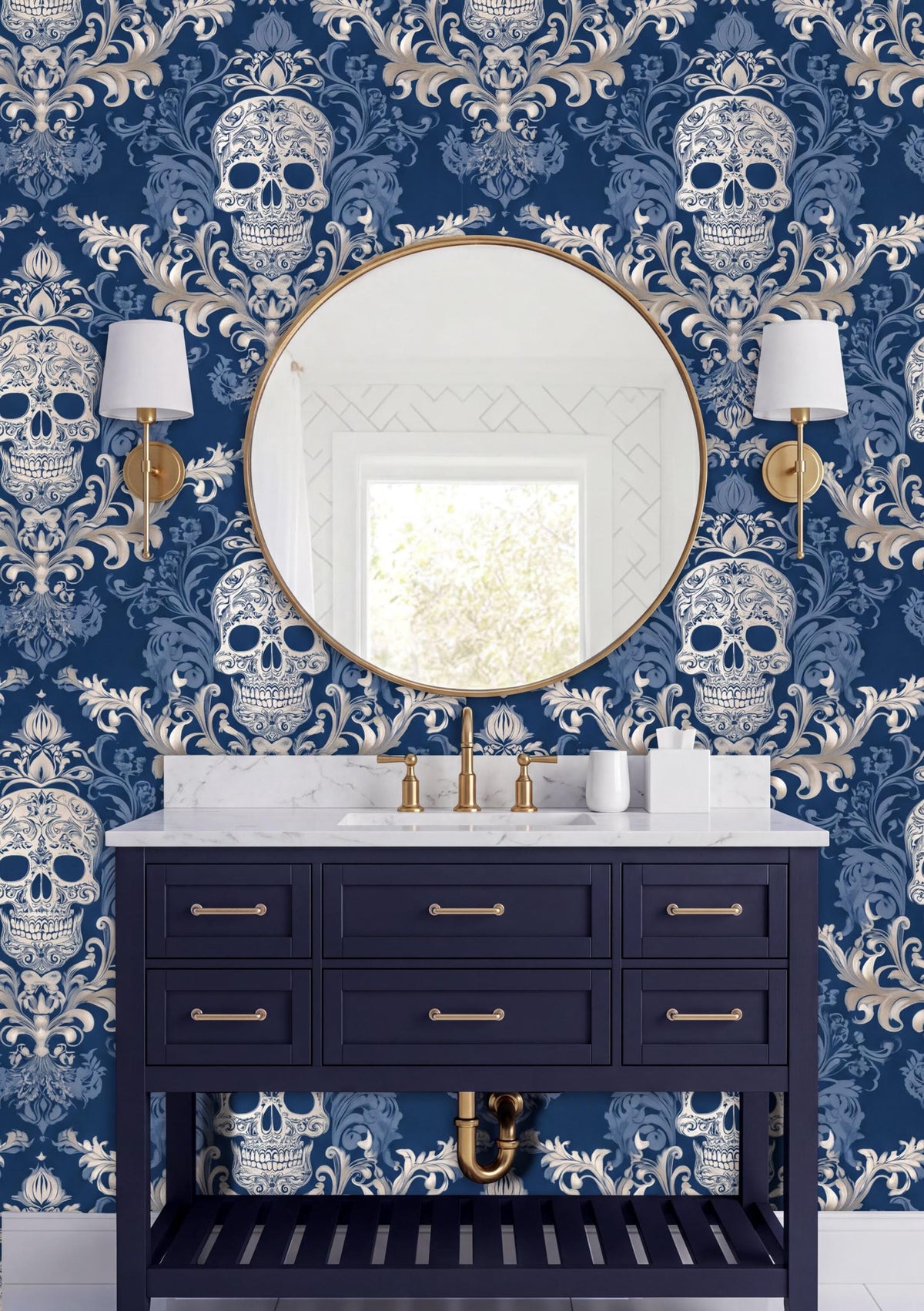 a bathroom vanity with a dark blue color and gold fixtures, set against a blue and white skull wallpaper. The vanity has a round mirror above it, and two white wall sconces flank the mirror.