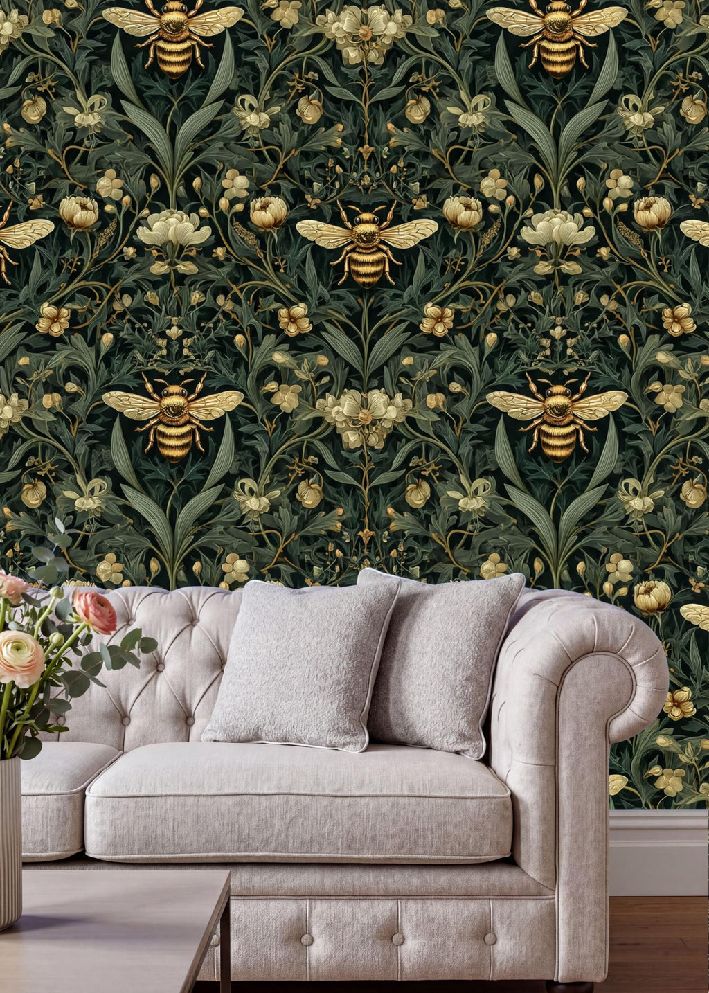 a white sofa with two gray pillows, set against a wallpapered wall with a repeating pattern of gold and green flowers and bees.